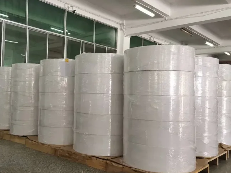 Jumbo thermal paper rolls stocked on pallets in the warehouse